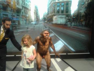 Un vigilante hace bajar a una niña de un diorama de Cosmocaixa, anoche.