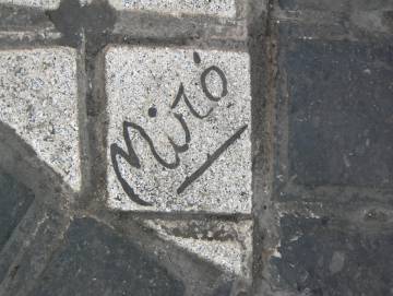 La signatura de l'artista en un de les peces que configuren el mosaic.