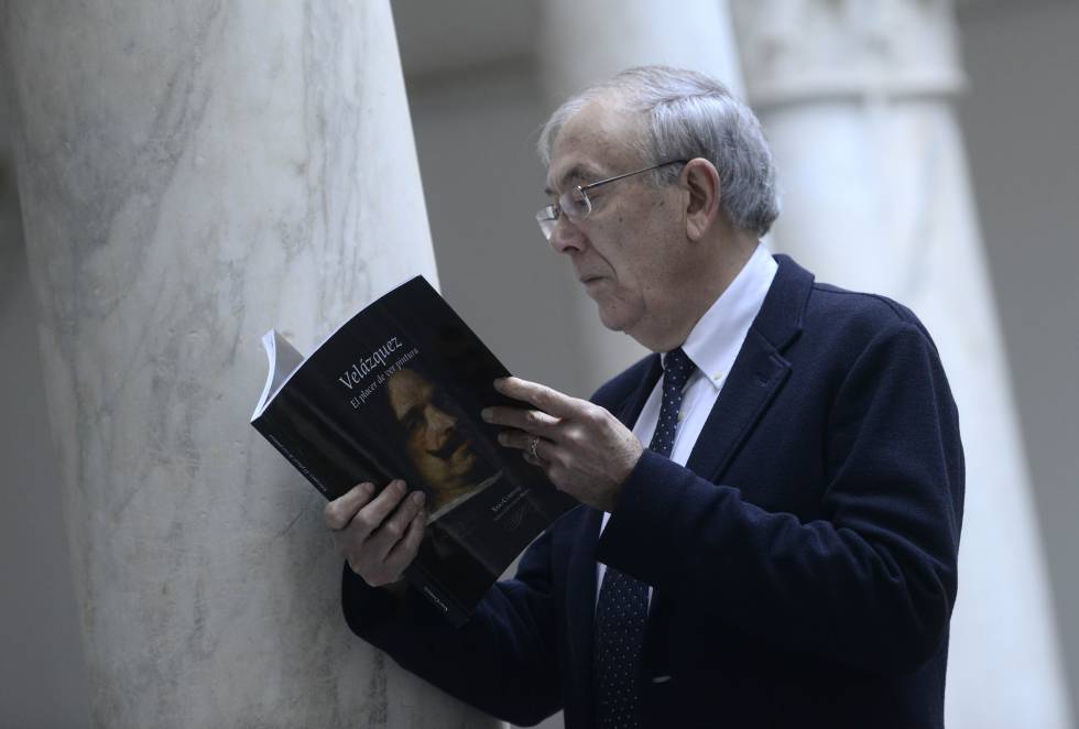 Ximo Company, con su libro sobre Velázquez, en el Museo de Bellas Artes de Valencia, donde se guarda el autorretrato del pintor de la portada.