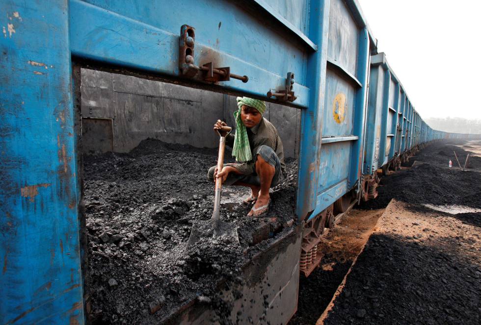 Un trabajador descarga carbón de un tren en la ciudad india de Chandigarh.