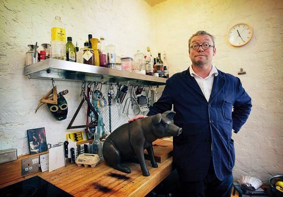 El chef inglés Fergus Henderson posa orgulloso junto a una reproducción de su animal favorito: el cerdo