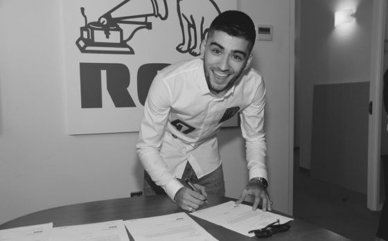 Zayn Malik firmando en contrato con el sello discográfico RCA.