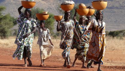 Mujeres de la tribu peul en Mali con cuencos con ropa y leche.