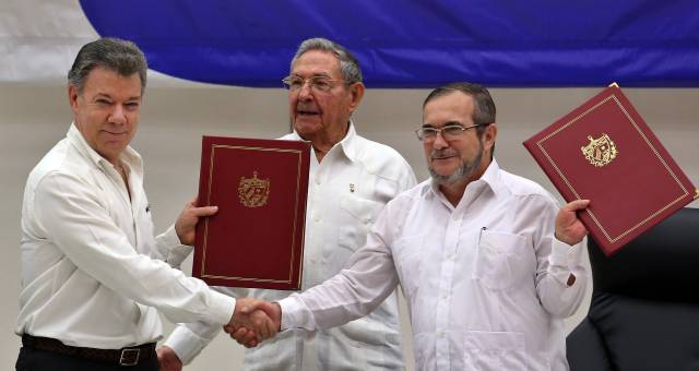 El delegado de las FARC en Cuba, Rodrigo Londoño Echeverri, y el presidente de Colombia, Juan Manuel Santos (i) junto a el presidente de Cuba, Raúl Castro (c) sostienen en sus manos el acuerdo de paz. El delegado de las FARC en Cuba, Rodrigo Londoño Echeverri, y el presidente de Colombia, Juan Manuel Santos (i) junto a el presidente de Cuba, Raúl Castro (c) sostienen en sus manos el acuerdo de paz.