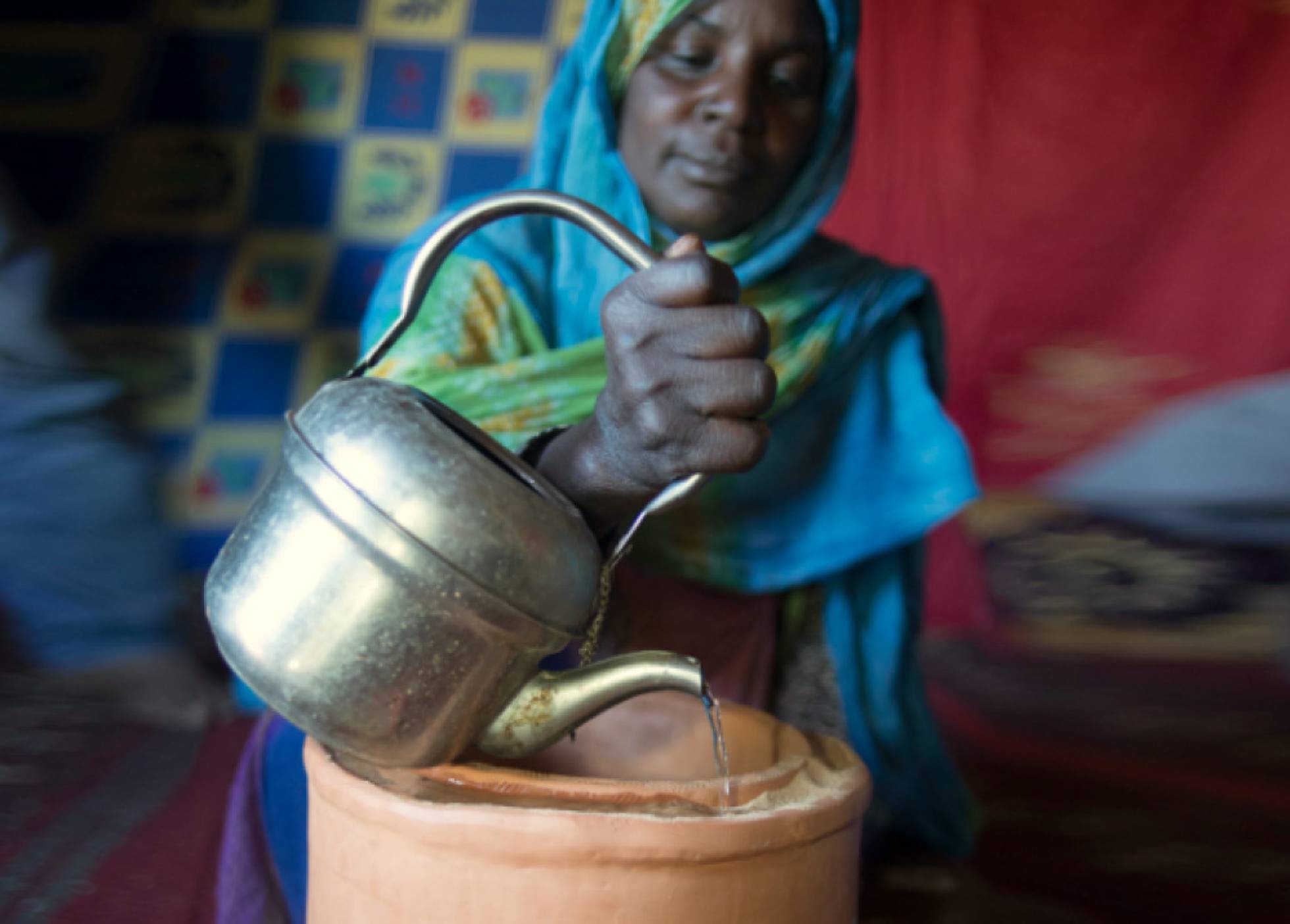 Una refugiada saharaui utiliza un zeer, un refrigerador casero hecho con arena, en Argelia. Una refugiada saharaui utiliza un zeer, un refrigerador casero hecho con arena, en Argelia.