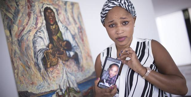 Mariam Berete with a photo of her biological son. Mariam Berete with a photo of her biological son.