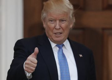 President-elect Donald Trump calls out to media as he poses for photos with BET founder Robert Johnson at the Trump National Golf Club Bedminster clubhouse, Sunday, Nov. 20, 2016, in Bedminster, N.J.. (AP PhotoCarolyn Kaster)