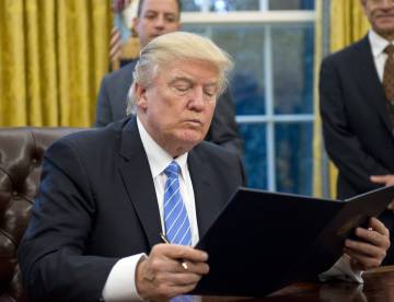 President Donald Trump signing an executive order. President Donald Trump signing an executive order.