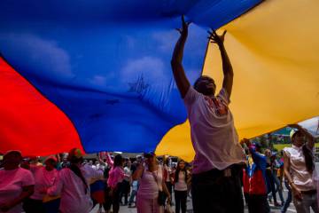 Marchers protesting violence in Venezuela, whose regime Podemos has failed to criticize.
