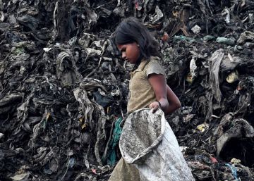 Una niña busca entre la basura de un vertedero en Guwahati (India) en una image de este lunes.