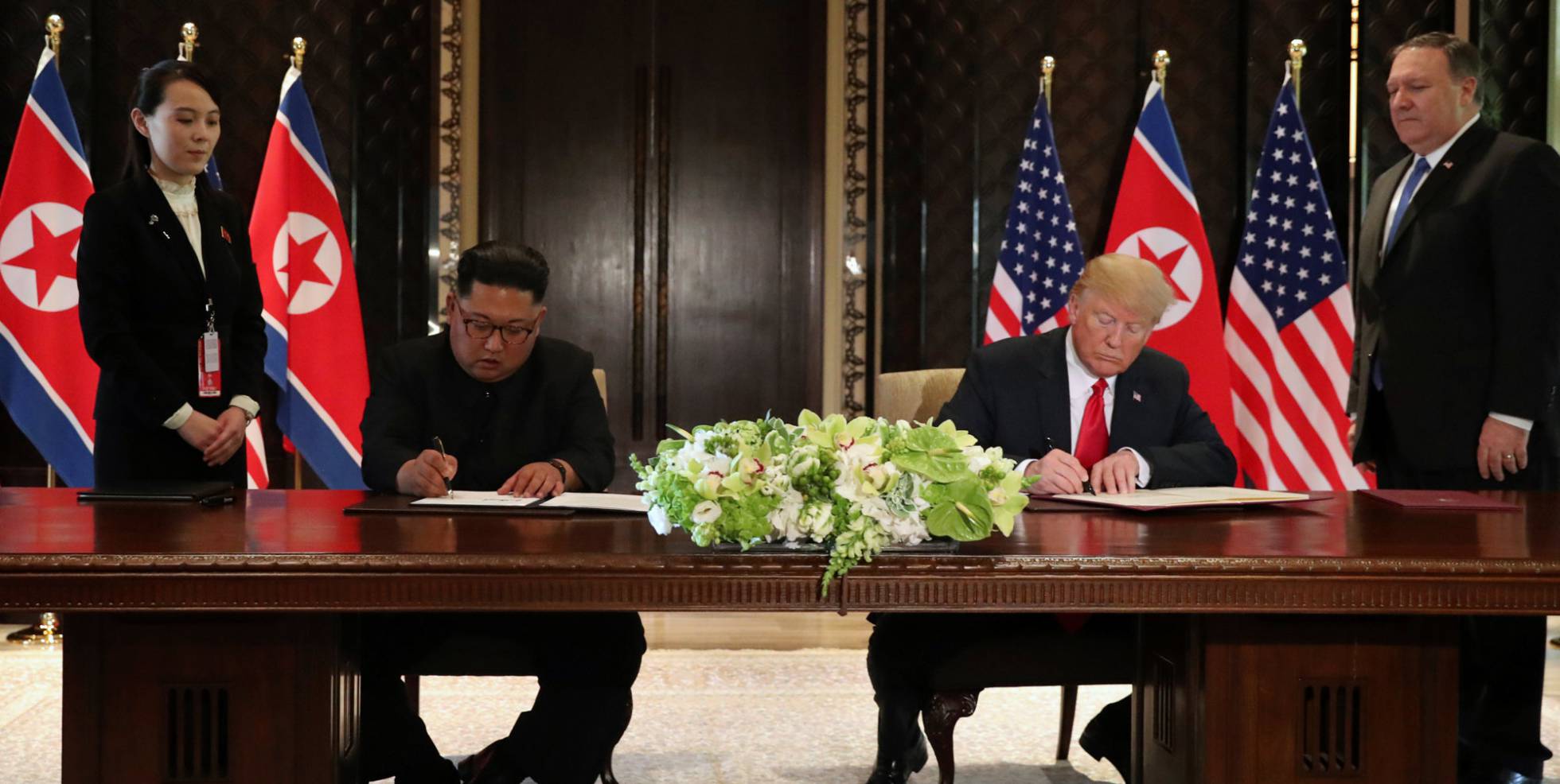 U.S. President Donald Trump and North Korea's leader Kim Jong Un sign documents that acknowledge the progress of the talks and pledge to keep momentum going, after their summit at the Capella Hotel on Sentosa island in Singapore June 12, 2018. As they are watched by Kim Yo Jong, sister of North Korean leader Kim Jong Un and U.S. Secretary of State Mike Pompeo. REUTERSJonathan Ernst