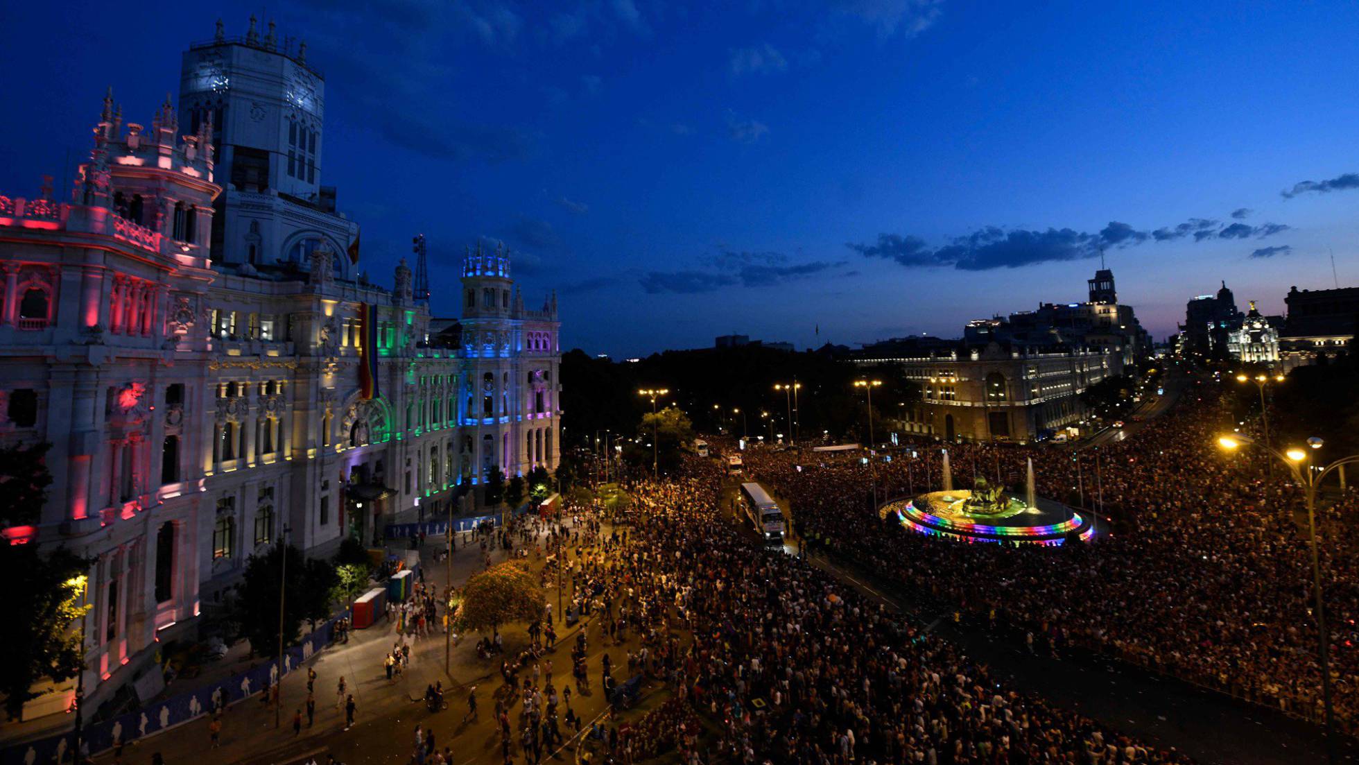 Revellers take part in the Gay Pride 2018 parade at the Cibeles square illuminated with the colors of the rainbow flag in Madrid, on July 7, 2018, one of the world's biggest. AFP PHOTO OSCAR DEL POZO
