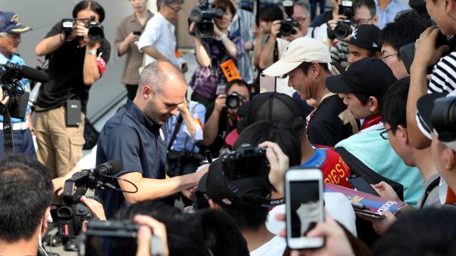 Iniesta firma autógrafos a su llegada a Kansai.