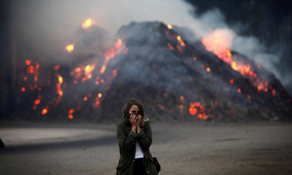Una mujer se protege del humo en As Neves (Pontevedra) el pasado octubre.