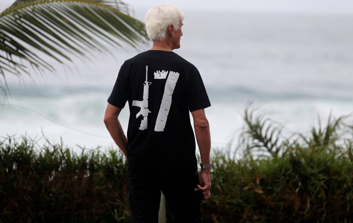 A supporter of Brazil's new president-elect, Jair Bolsonaro, is seen in front of Bolsonaro's condominium at Barra da Tijuca neighborhood in Rio de Janeiro, Brazil October 29, 2018. REUTERSSergio Moraes