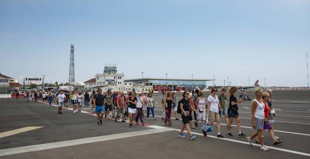 Visitors cross the airport of Gibraltar.