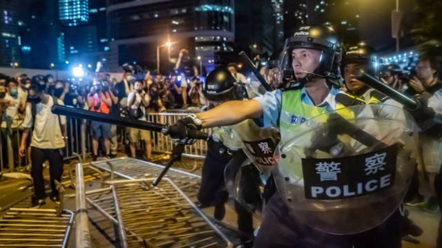 Riot police and protestors during a demonstration last week in Hong Kong.