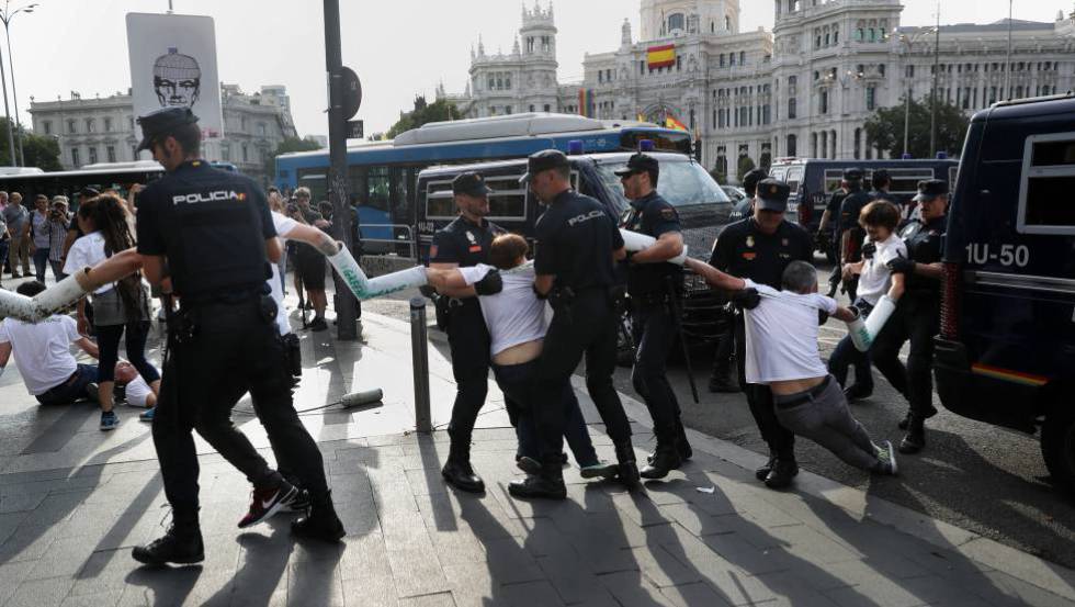 Police clear environmental protestors in Madrid on Monday.