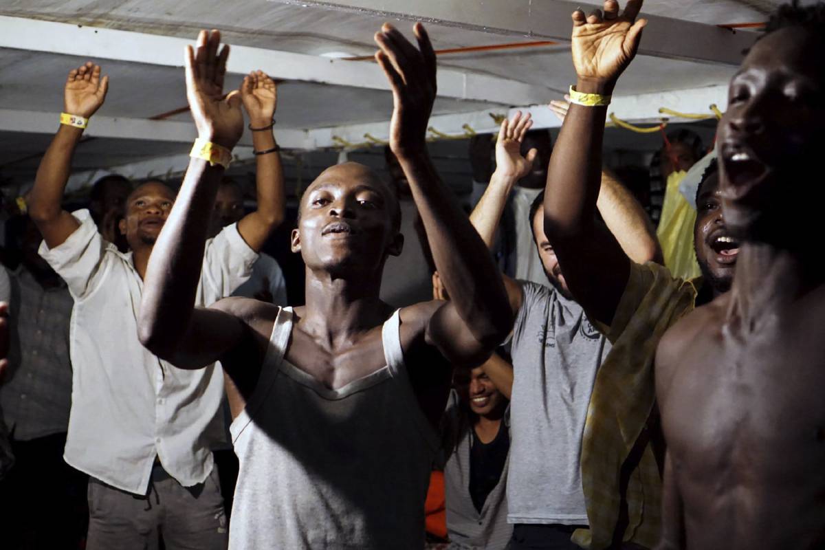 Migrants on board the ‘Open Arms’ celebrate.