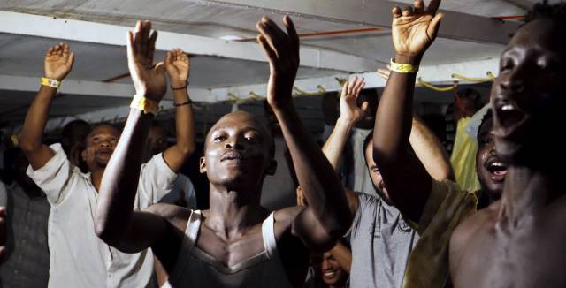 Migrants on board the ‘Open Arms’ celebrate.
