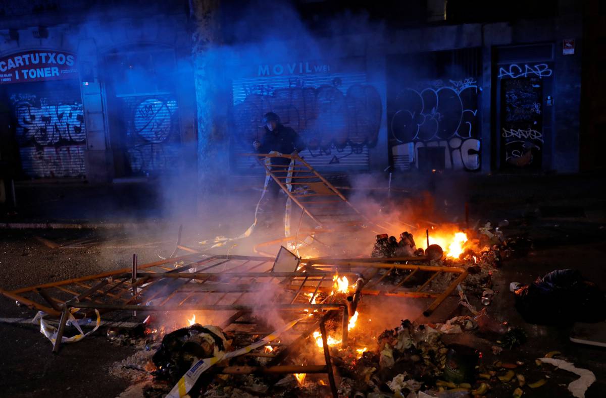 A police officer removes a barricade during a protest in Barcelona.
