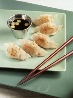 Un plato de gyōza, empanadillas rellenas preparadas a la plancha. Un plato de gyōza, empanadillas rellenas preparadas a la plancha.