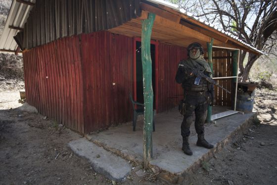 A policeman stands outside a hut that La Tuta used as a hideout.