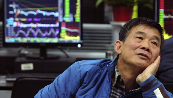 Un inversor frente a una pantalla de cotizaciones en Jiangxi (China)