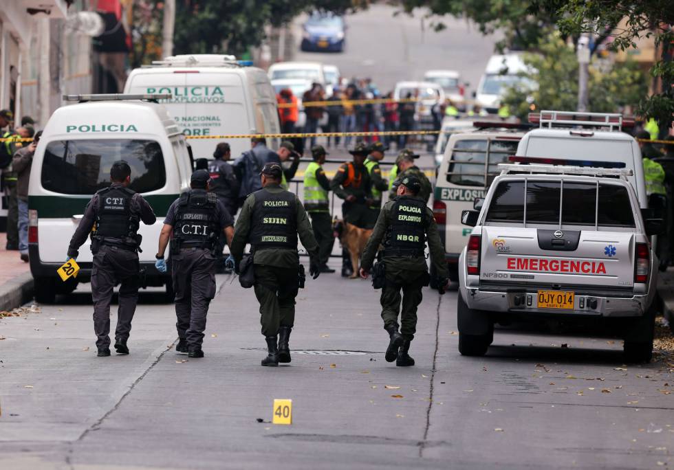 Miembros de la Policía de Colombia examinan el lugar donde se ha registrado una explosión la mañana del domingo, en Bogotá.