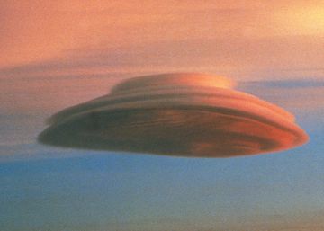 Un esquiador observa una nube lenticular desde la cumbre de un volcán inactivo en Hawái.