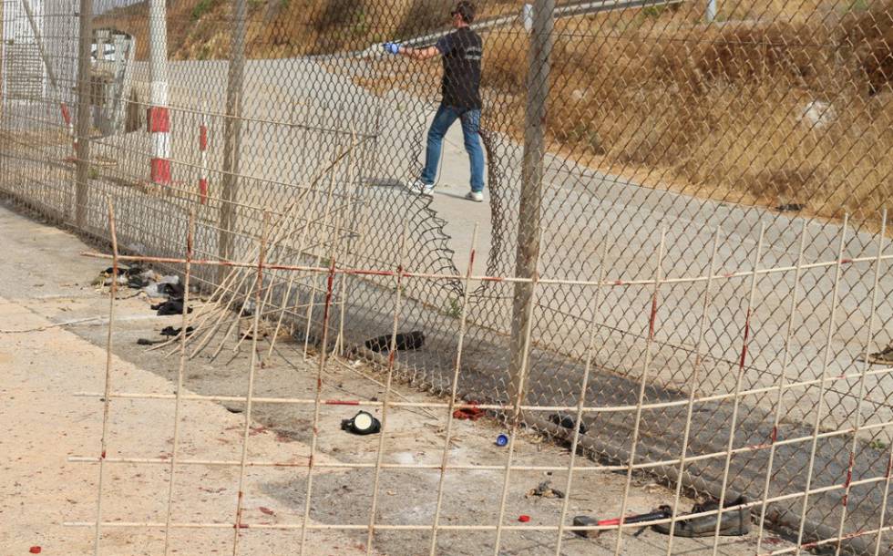 Agujero abierto en la valla para la intrusión en hoy en Ceuta. Abajo, a la derecha, un martillo y una cicalla.