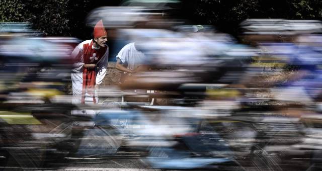 Un hombre disfrazado de cura anima a los corredores.