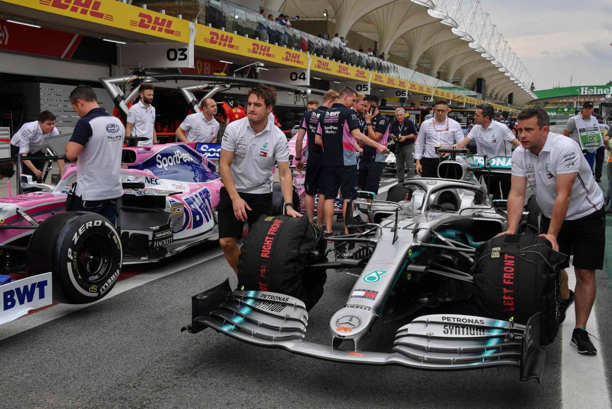 Technicians move the Mercedes Lewis Hamilton's car in the pits at the Interlagos racetrack in Sao Paulo, Brazil on November 14, 2019, ahead of the upcoming Formula One Brazilian Grand Prix on November 17. (Photo by NELSON ALMEIDA AFP)