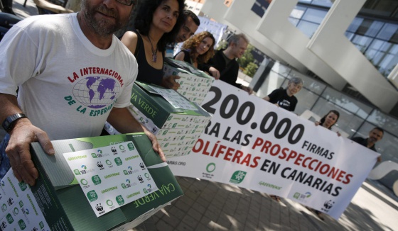 Representantes de los ecologistas, en la entrega de las firmas en la sede de Repsol en Madrid.