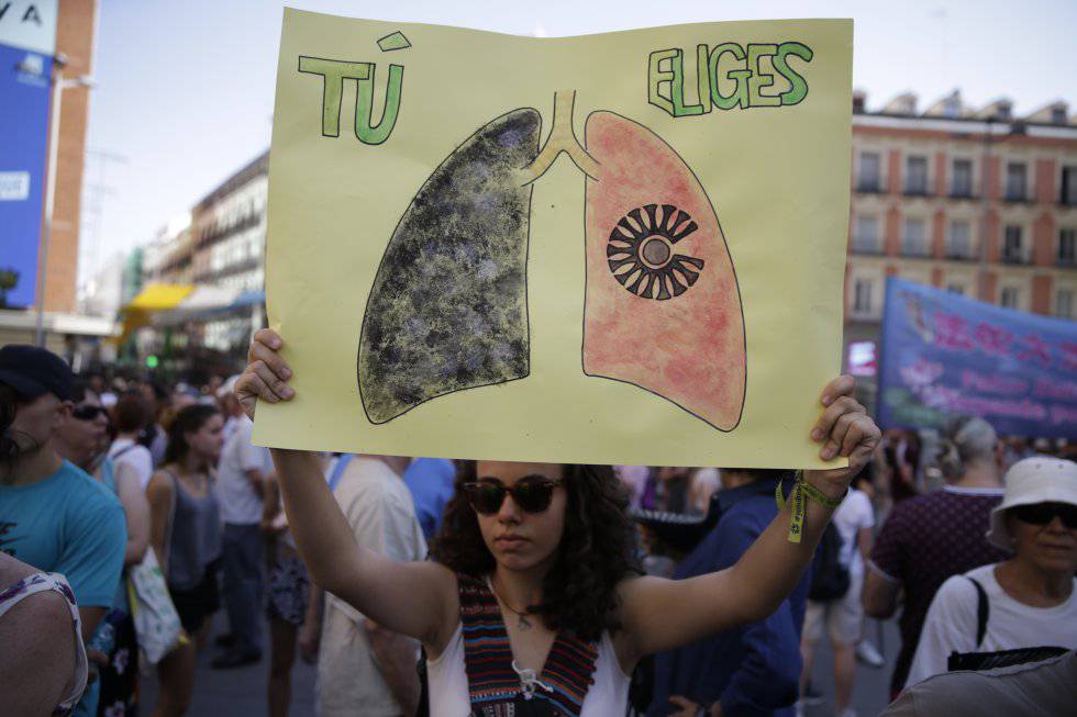 A woman with a sign that reads “You choose.”