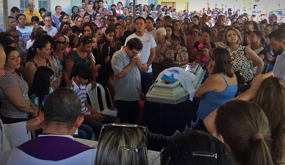 Marido faz preces diante do caixão de Heley durante o velório.