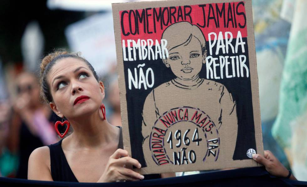 Uma manifestante segura uma placa contra a comemoraÃ§Ã£o do 55Âº aniversÃ¡rio do golpe militar, no Rio de Janeiro.