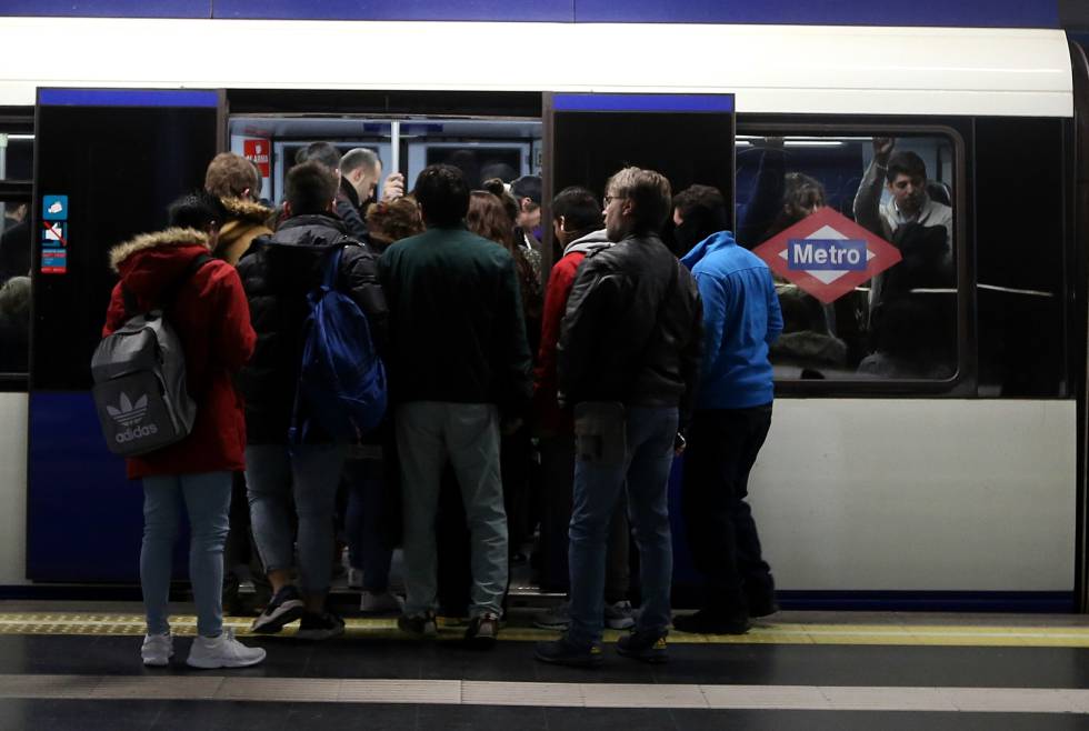 Decenas de viajeros tratan de entrar en un vagón del metro en la estación de Príncipe Pío.