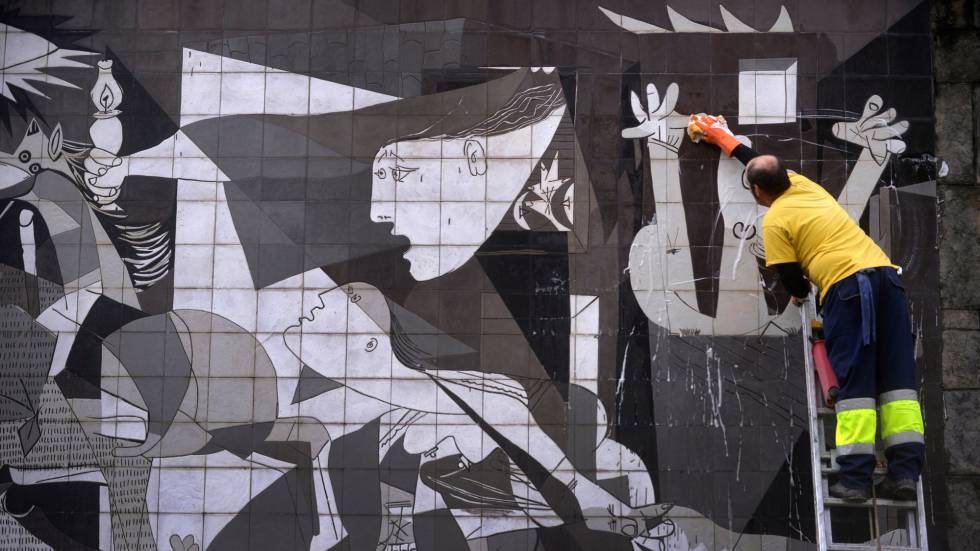 Un trabajador municipal limpia una reproducción de 'El Guernica' de Picasso en Guernica (País Vasco).