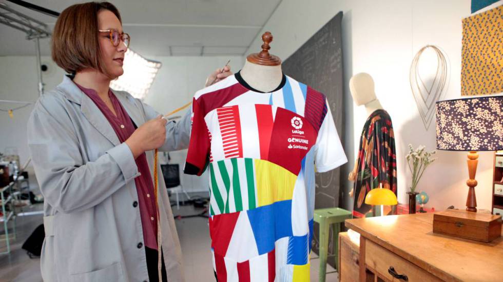 Aloma Lafontana, artista y diseñadora de la camiseta construida con retazos de las de los 36 equipos participantes en LaLiga Genuine Santander, posa con su creación.