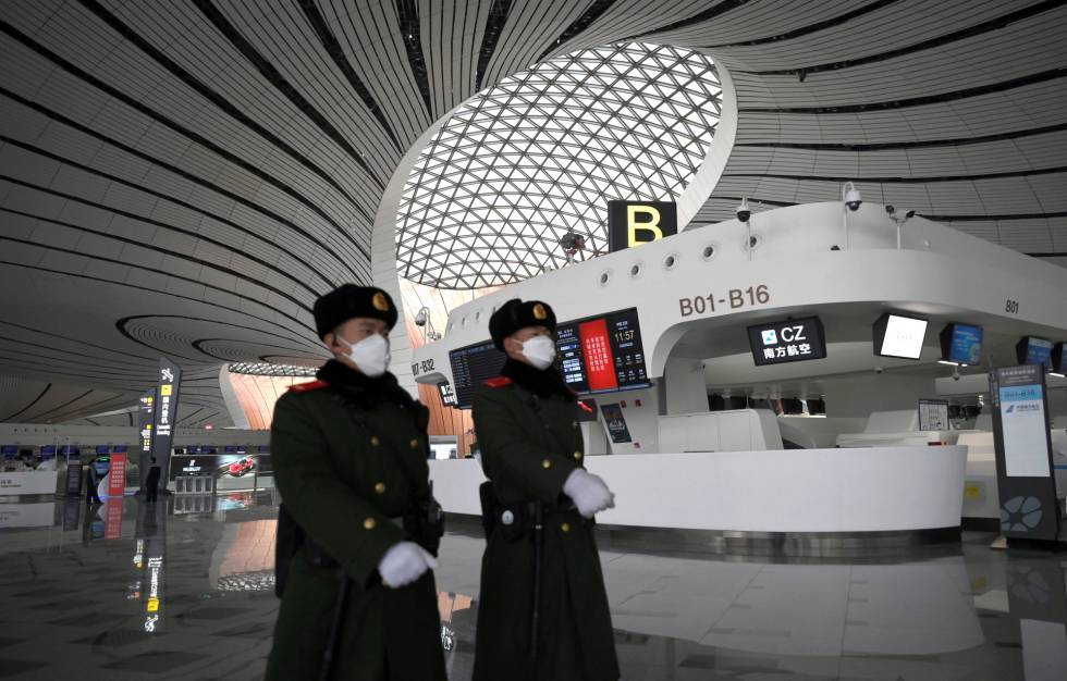 Police officers patrol at the Beijing airport.