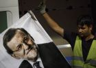 A worker removes a campaign poster for the national elections depicting Spain's Prime Minister and Popular Party candidate Mariano Rajoy, in Madrid, Spain, Monday, Dec. 21, 2015. A strong showing Sunday by a pair of upstart parties in Spain's general election upended the country's traditional two-party system, with the ruling Popular Party winning the most votes but falling far short of a parliamentary majority and at risk of being booted from power. (AP PhotoDaniel Ochoa de Olza)