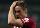 Atletico Madrid's forward Fernando Torres touches his head during the Spanish league football match Malaga CF vs Club Atletico de Madrid at La Rosaleda stadium in Malaga on December 20, 2015. AFP PHOTO  JORGE GUERRERO