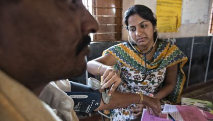 La estudiante de medicina Prathyusha toma la tensión a un paciente.