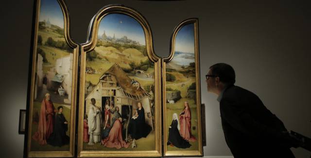 A visitor examines the ‘Adoration of the Magi.’