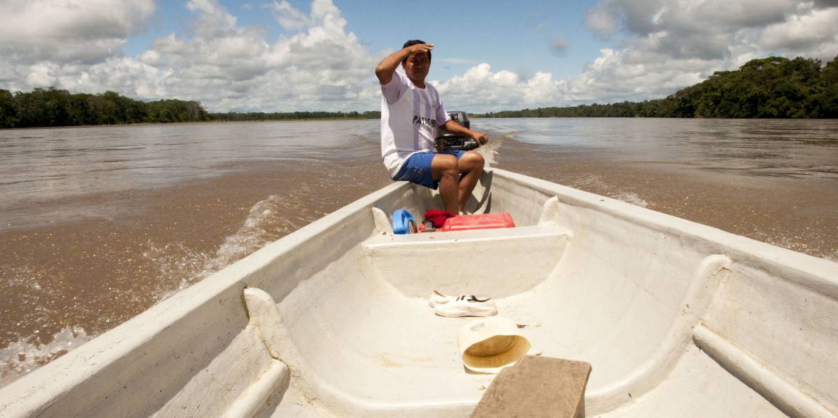 Juan navega en el inmenso río Napo y comenta que la explotación petrolera ha sido beneficiosa para su comuna, Puerto Miranda, en Ecuador.