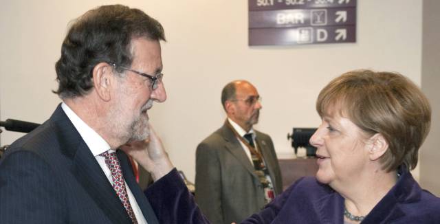 Rajoy and Merkel in December.