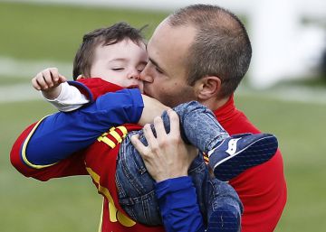 Iniesta abraza a su hijo durante el entrenamiento.