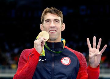 RIO DE JANEIRO, BRAZIL - AUGUST 11: Gold medalist Michael Phelps of the United States celebrates during the medal ceremony for the Men's 200m Individual Medley Final on Day 6 of the Rio 2016 Olympic Games at the Olympic Aquatics Stadium on August 11, 2016 in Rio de Janeiro, Brazil. (Photo by Clive RoseGetty Images)