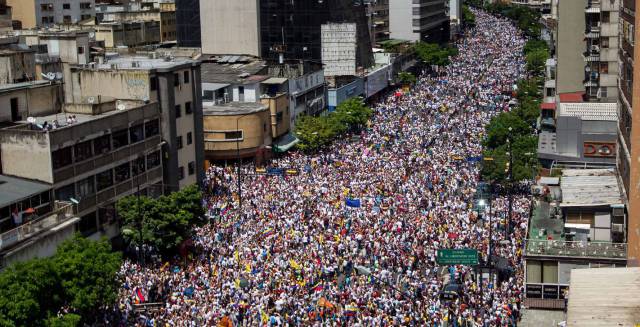 Thousands of people march on the streets of Caracas.
